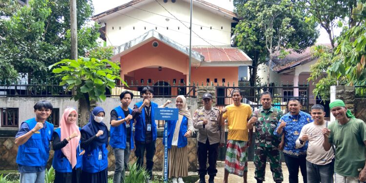 Mahasiswa KKP Fisip Unismuh bersama warga foto bersama usai memasang salah satu plang di Kelurahan Samata, Kecamatan Somba Opu, Kabupaten Gowa, Senin (18/11/2024)